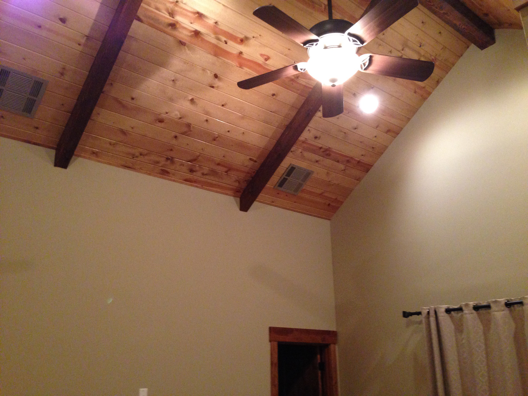 Bedroom with ceiling fan lighting.