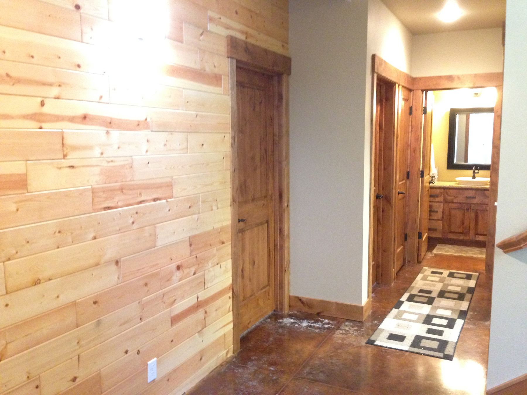 Bathroom entryway with decorative carpet.