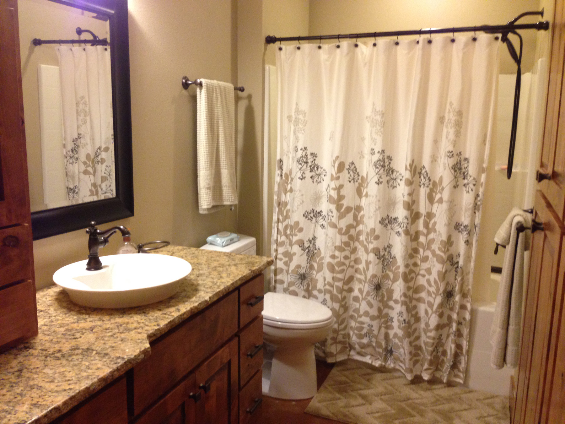 Bathroom view with shower curtain.