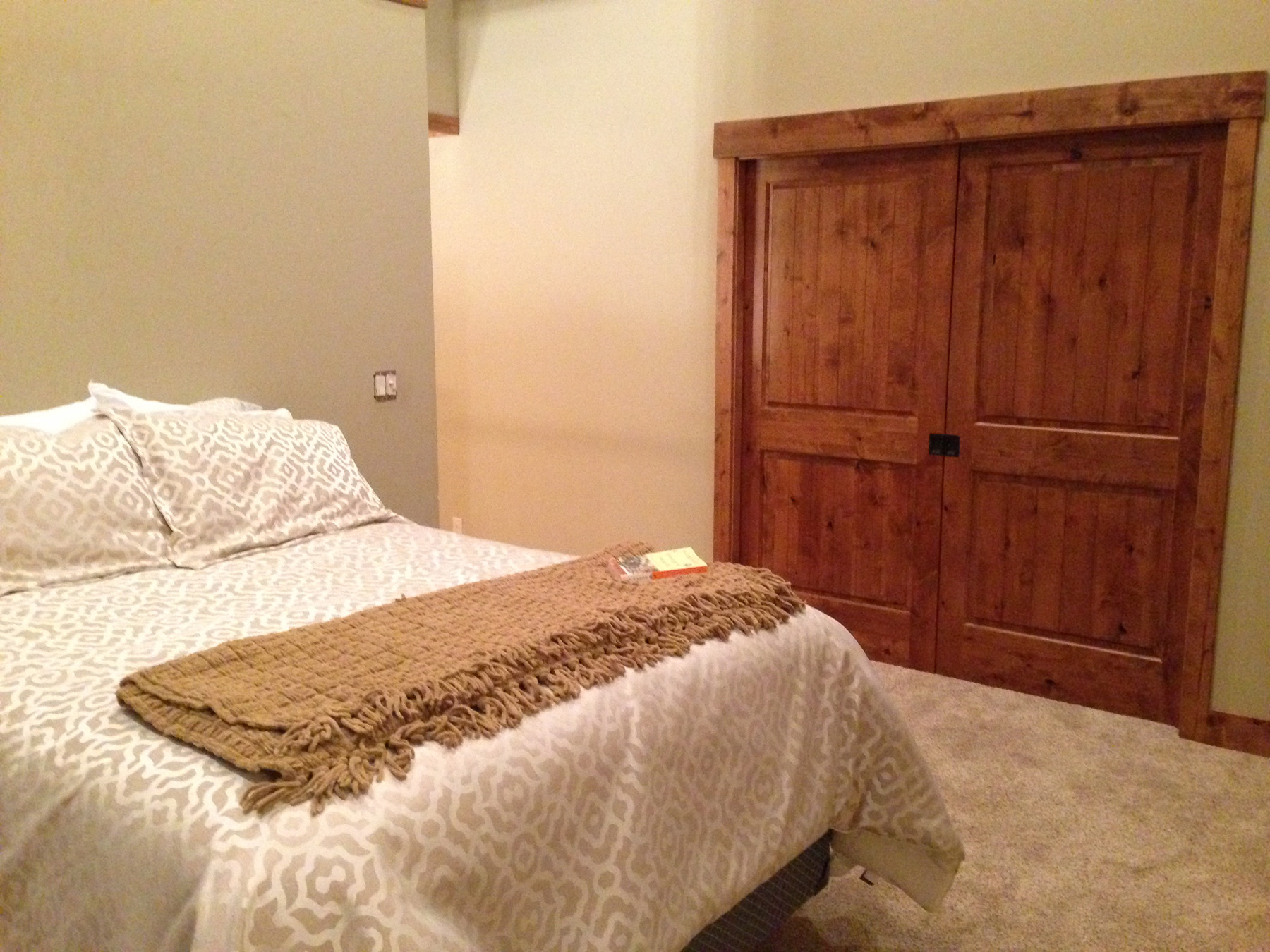 Different angle of bedroom with bed.