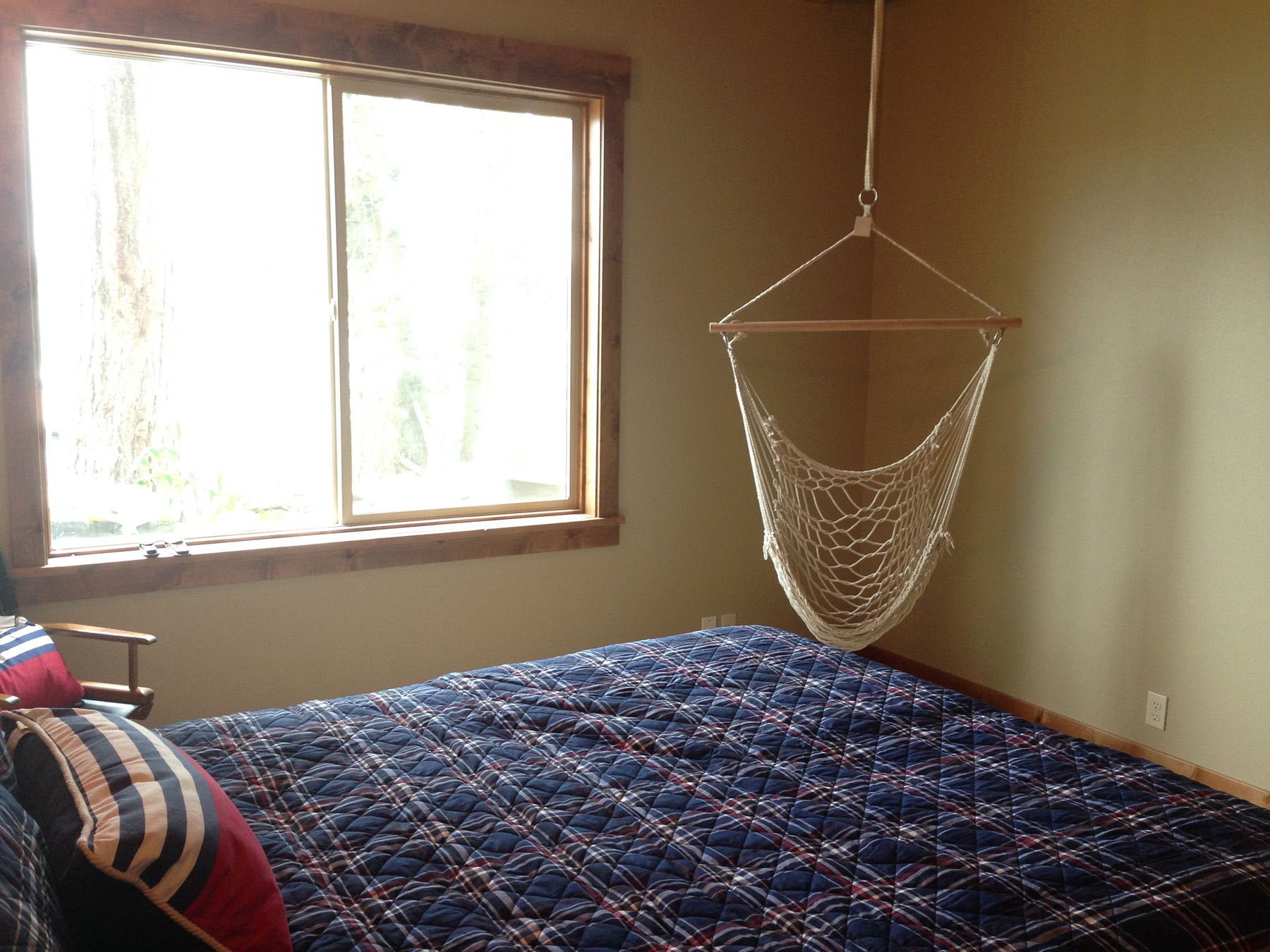 Bedroom featuring decorative hanging swing.