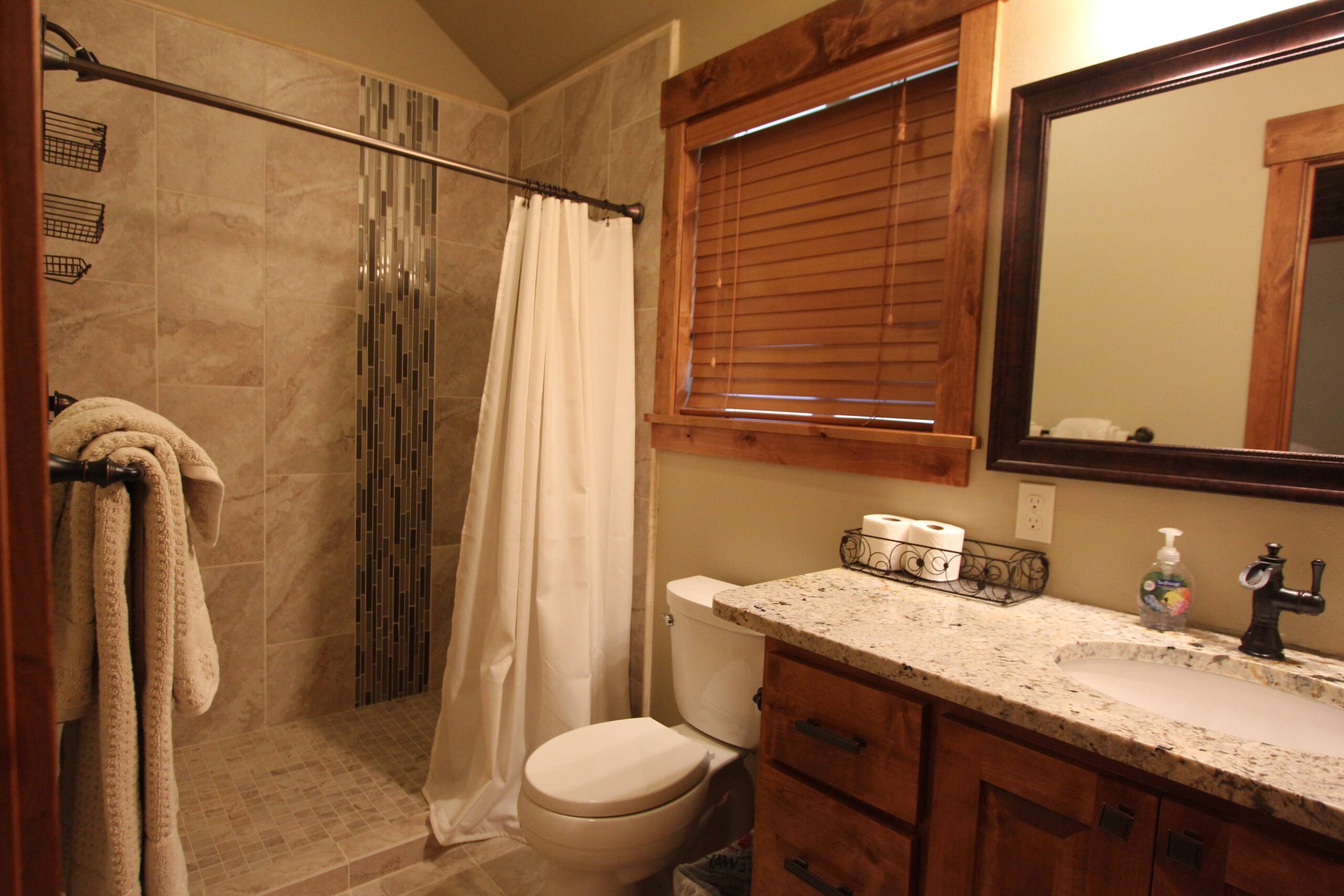 Bathroom with shower, sink, and toilet.