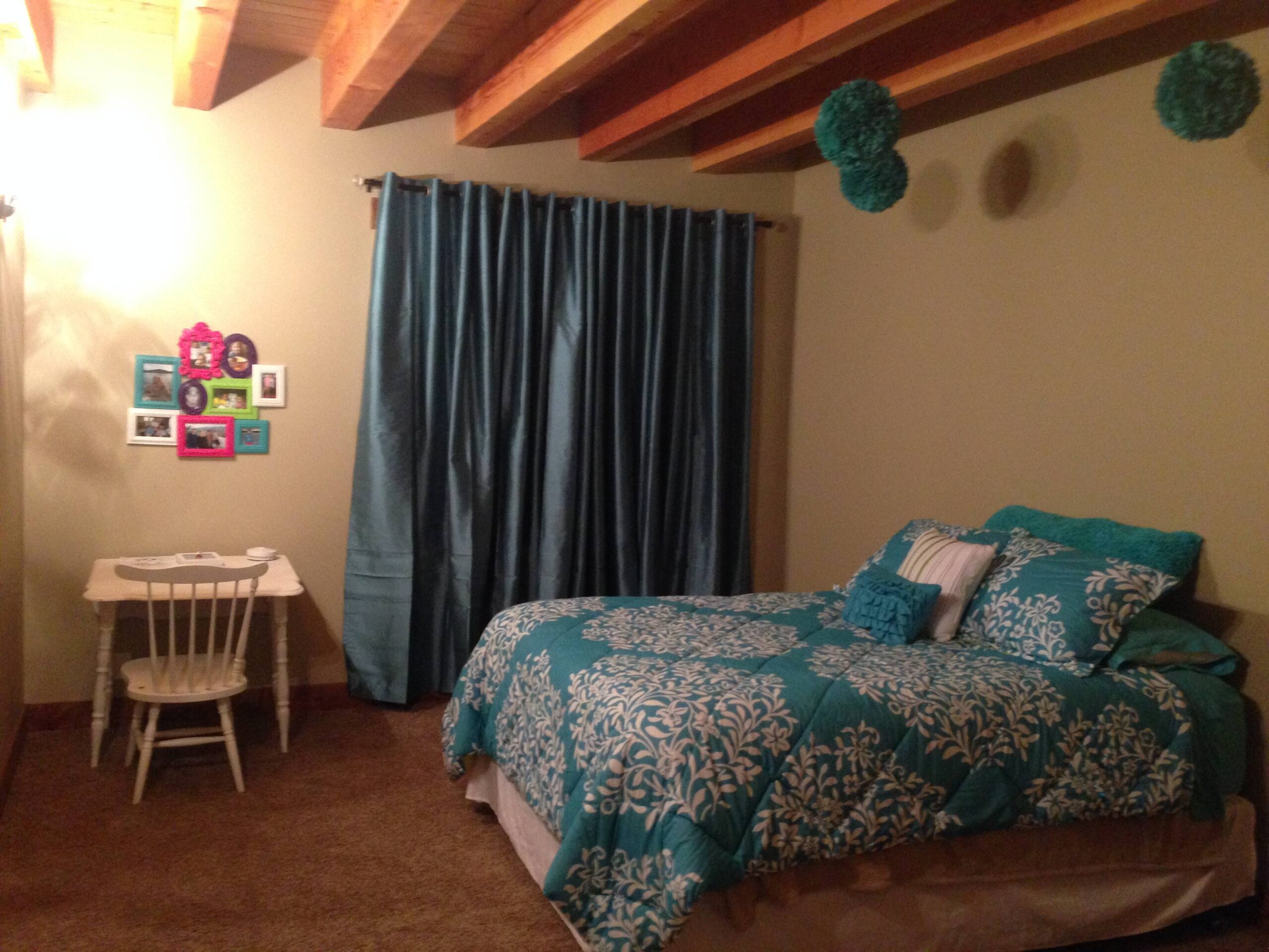 Bedroom with white and wooden furniture.
